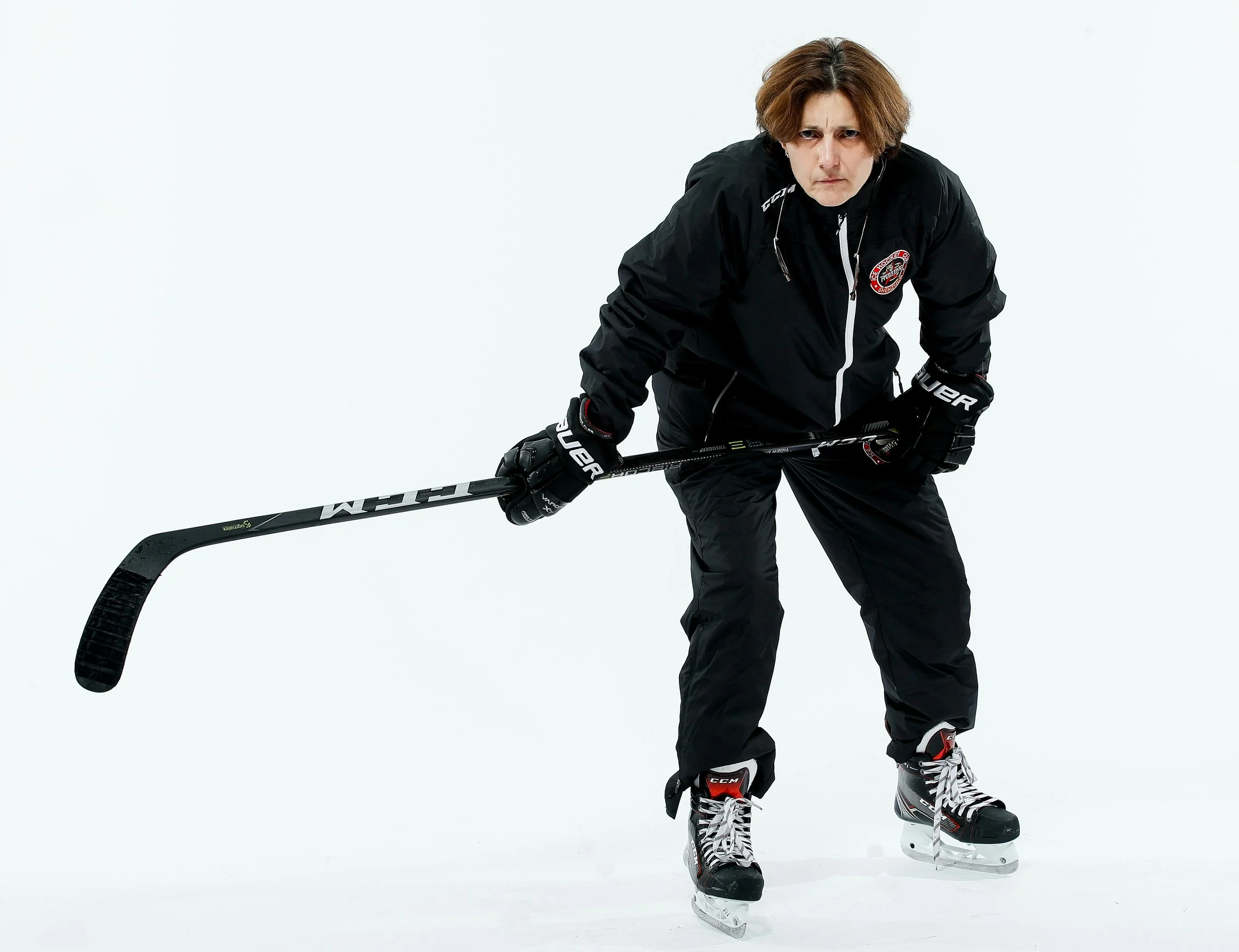Digit Murphy on the ice in hockey gear holding a stick